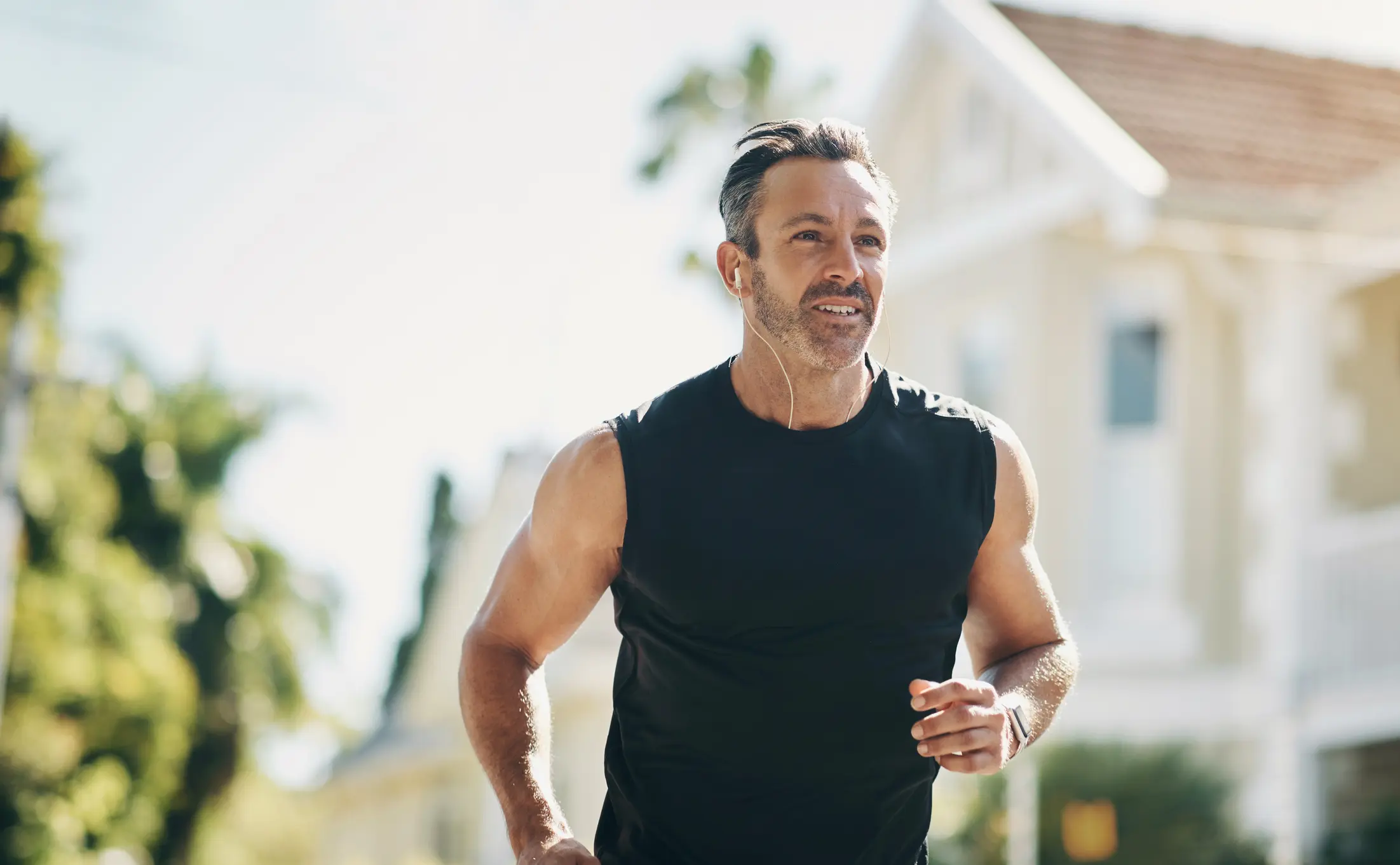 Middle-aged man jogging outdoors, representing healthy lifestyle improvements related to Low Testosterone and Body Composition.